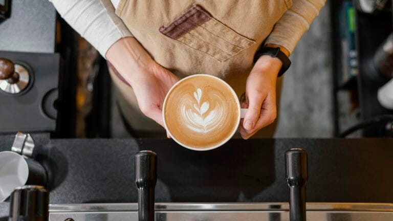 A female holding a cup of coffee at Starbucks